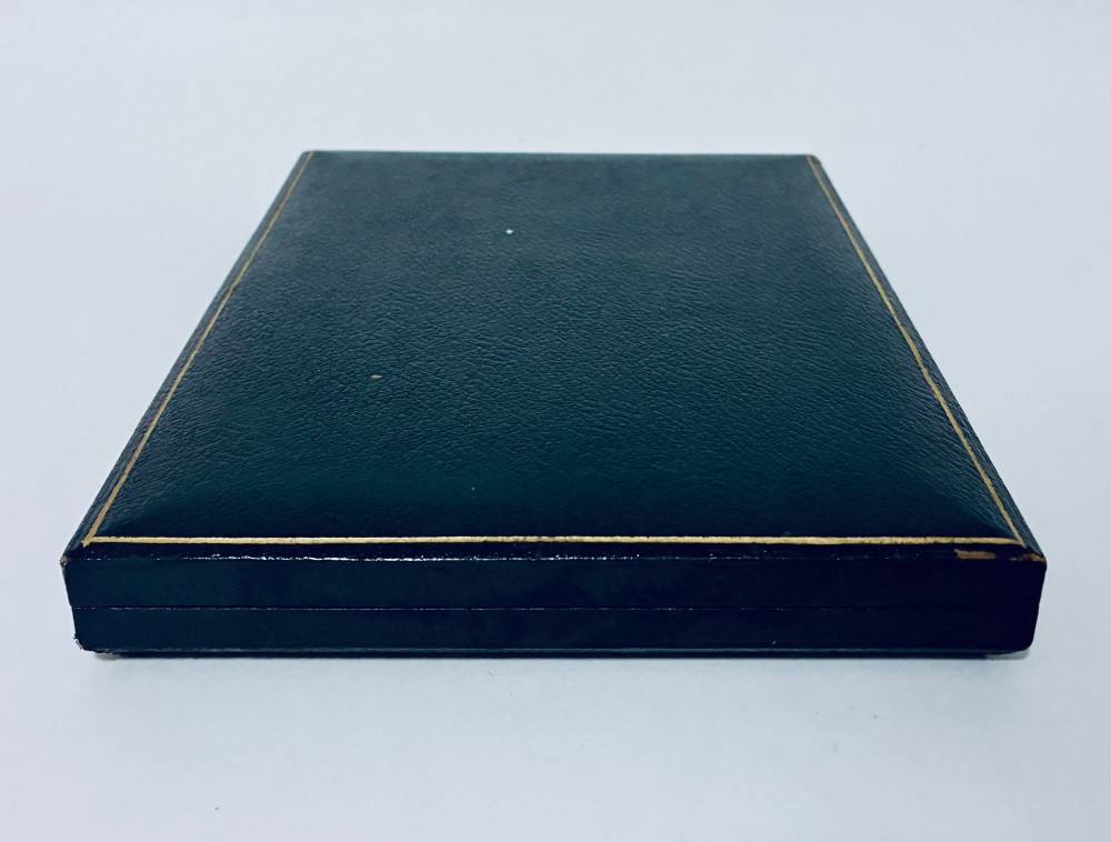 A cased set of six silver-handled butter knives with rounded blades displayed in a dark velvet-lined presentation box. View IX