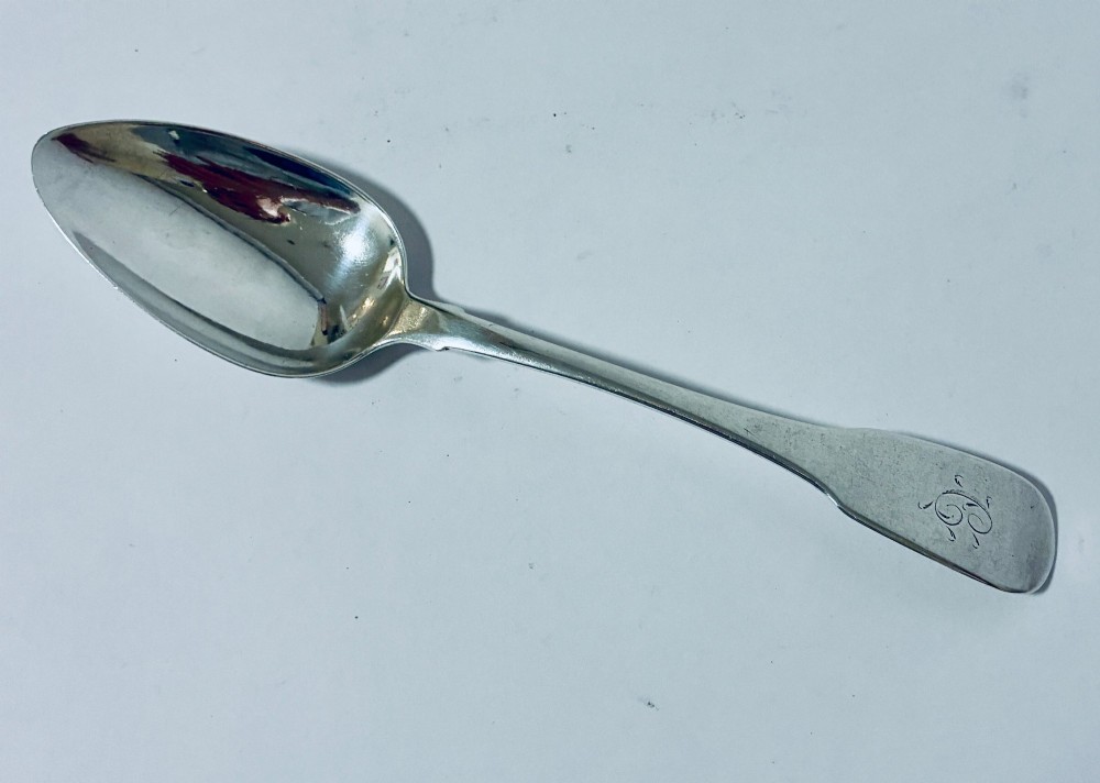 An antique Exeter sterling silver tablespoon featuring a classic fiddle pattern handle with an engraved monogram. View II