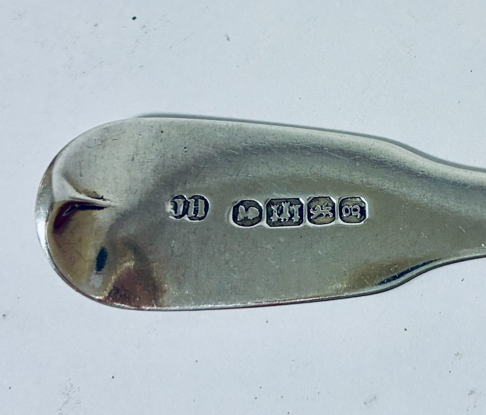An antique Exeter sterling silver tablespoon featuring a classic fiddle pattern handle with an engraved monogram. View VII