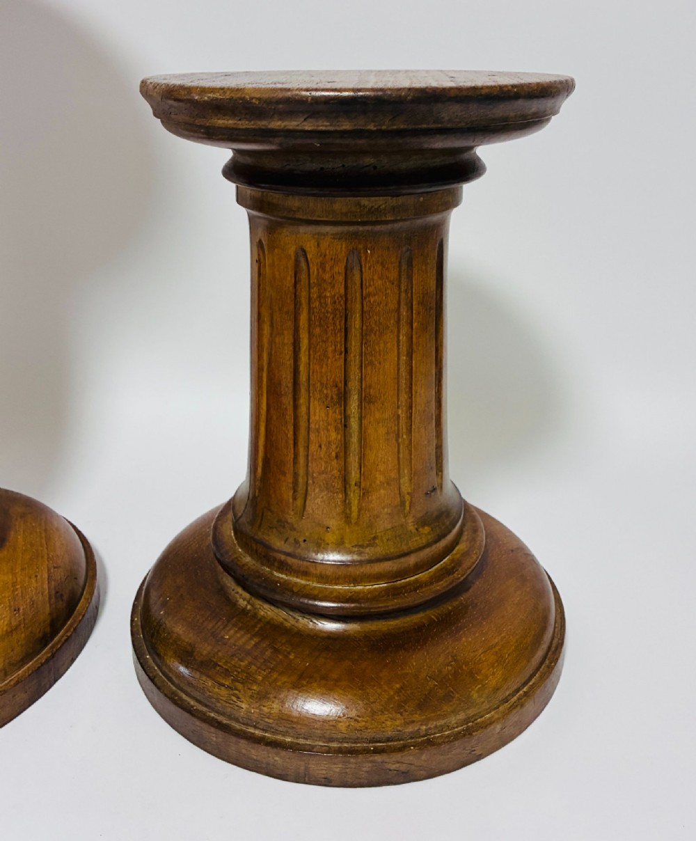 A pair of turned oak Neoclassical display pedestals featuring fluted columns and circular molded tops. View II