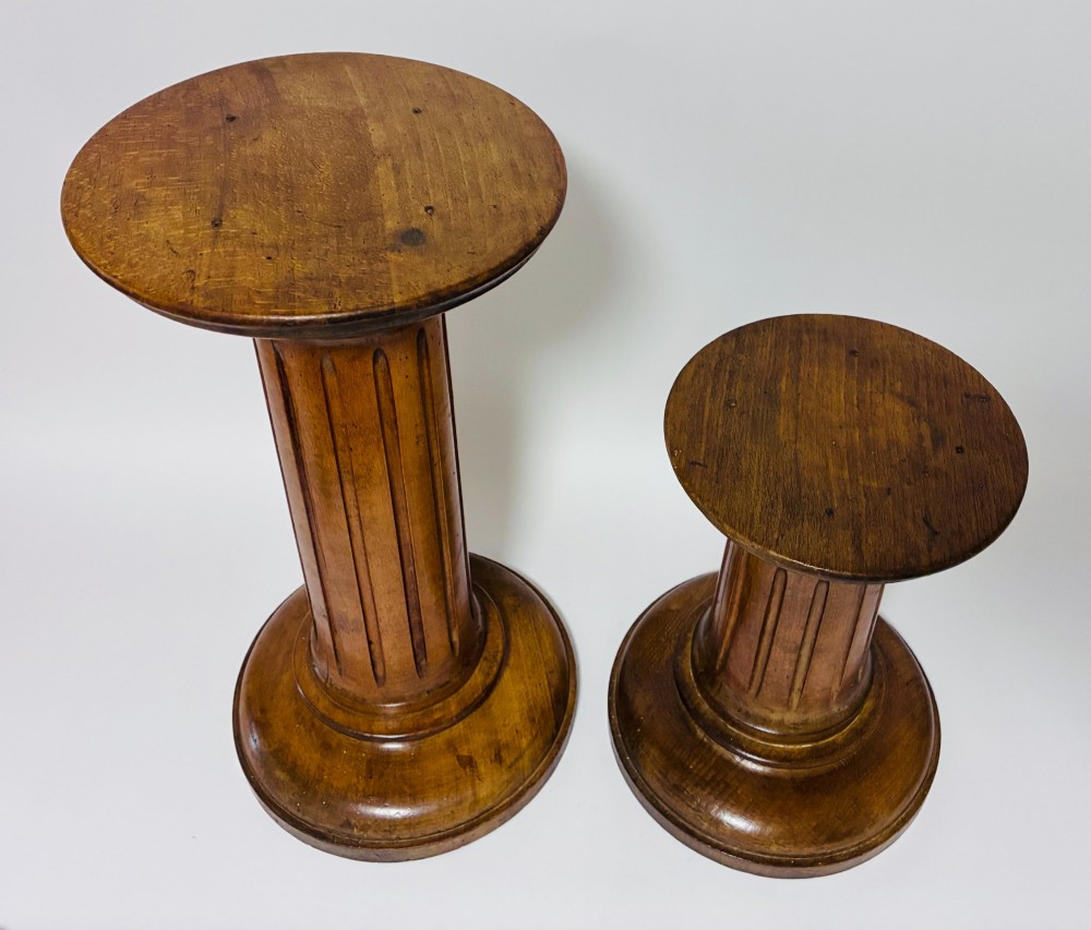 A pair of turned oak Neoclassical display pedestals featuring fluted columns and circular molded tops. View III