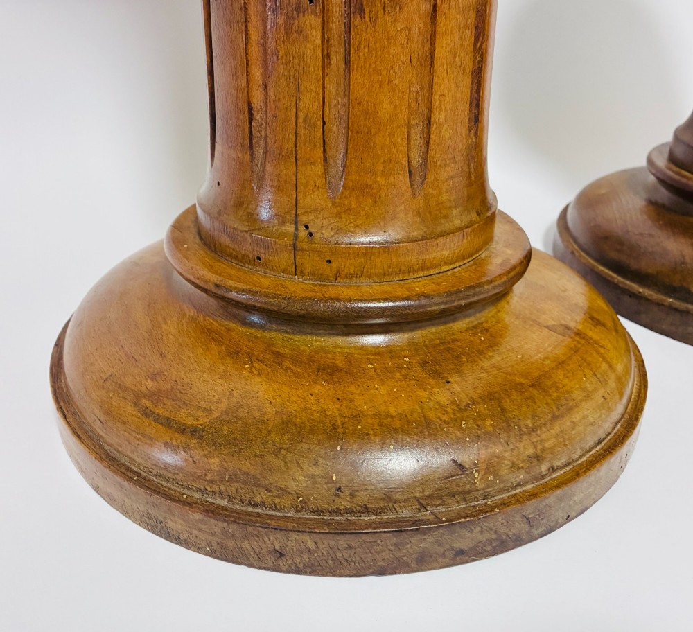 A pair of turned oak Neoclassical display pedestals featuring fluted columns and circular molded tops. View IV
