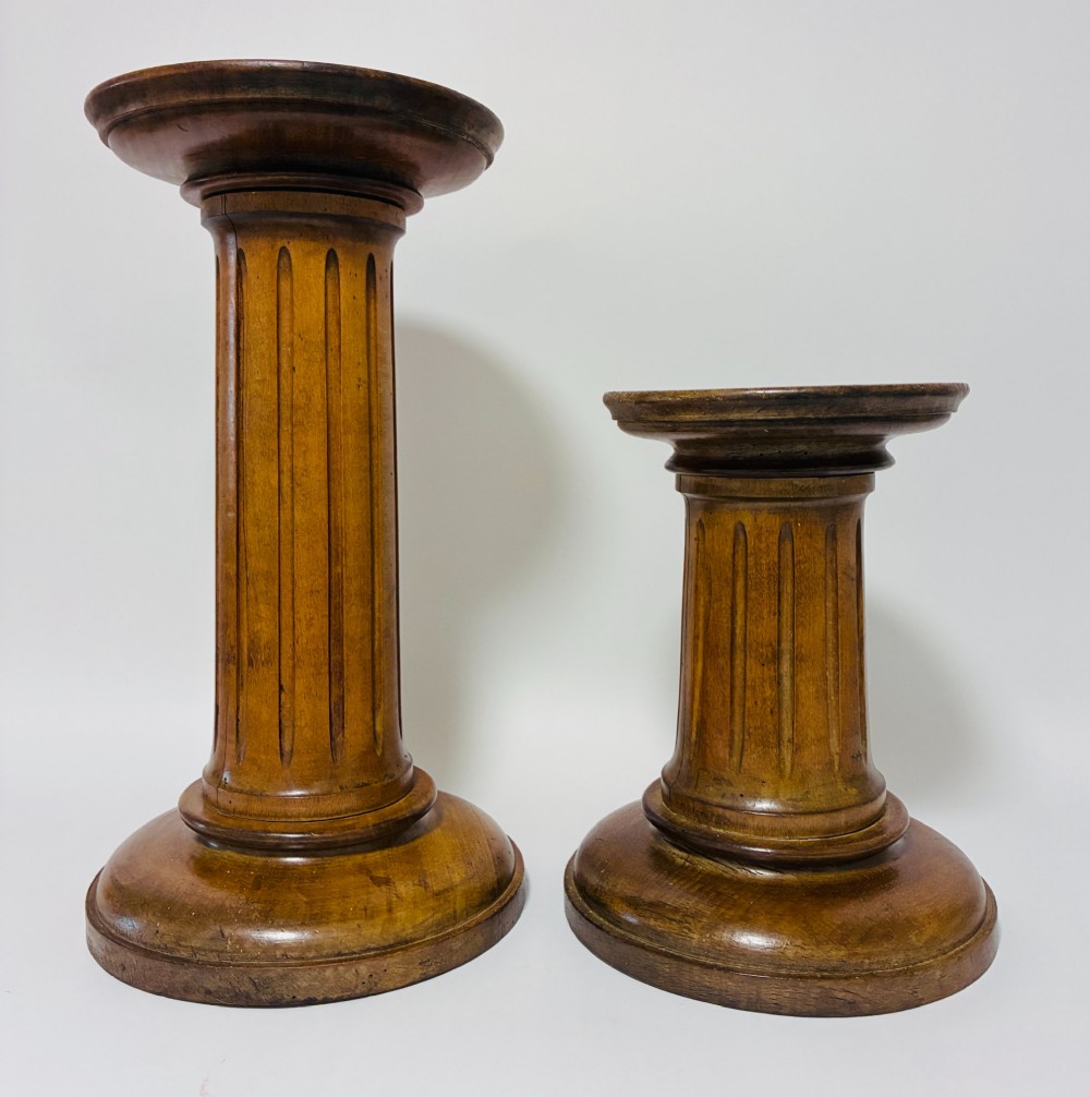 A pair of turned oak Neoclassical display pedestals featuring fluted columns and circular molded tops. View VI