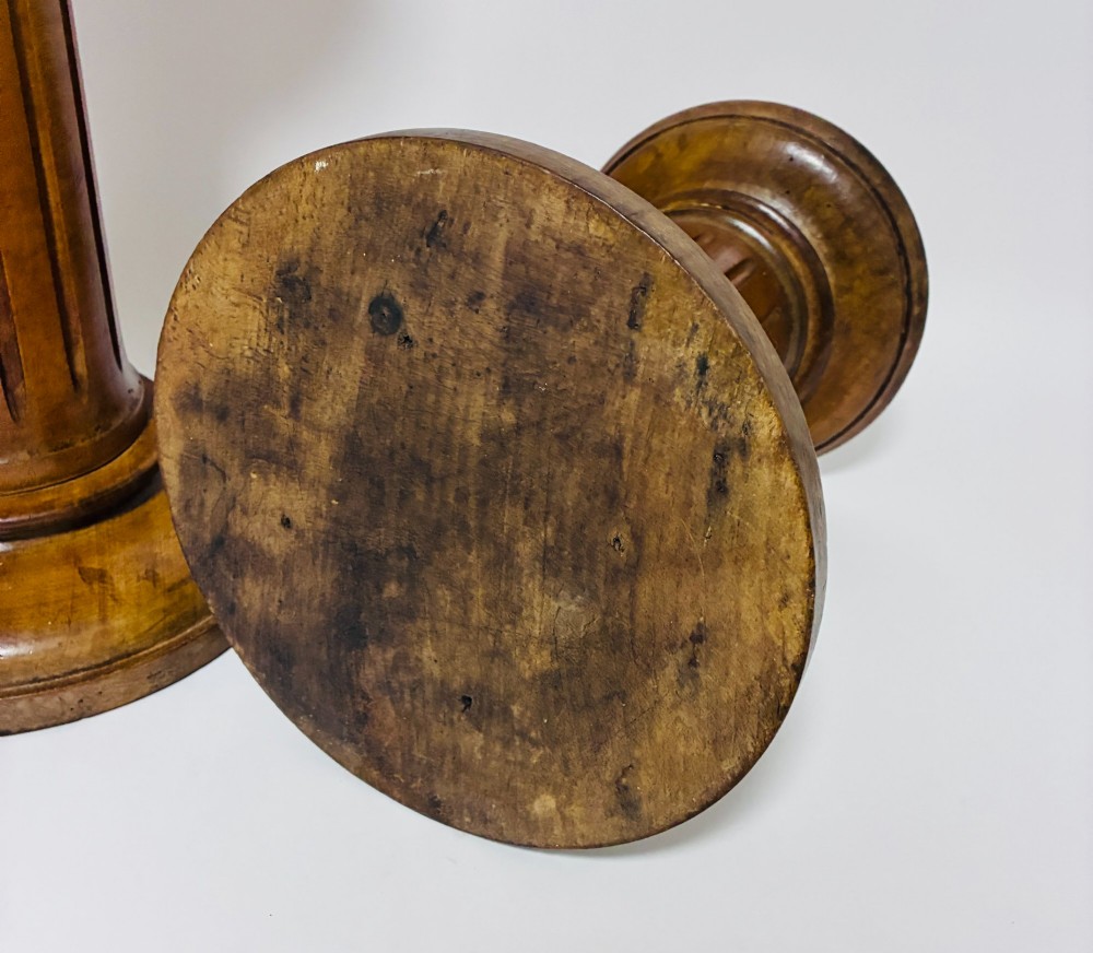 A pair of turned oak Neoclassical display pedestals featuring fluted columns and circular molded tops. View VII