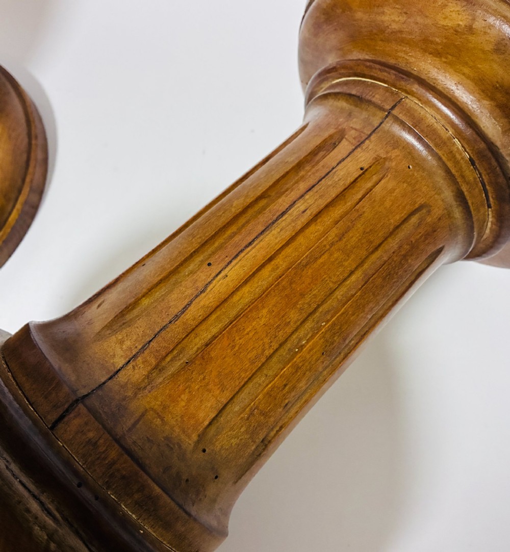 A pair of turned oak Neoclassical display pedestals featuring fluted columns and circular molded tops. View VIII