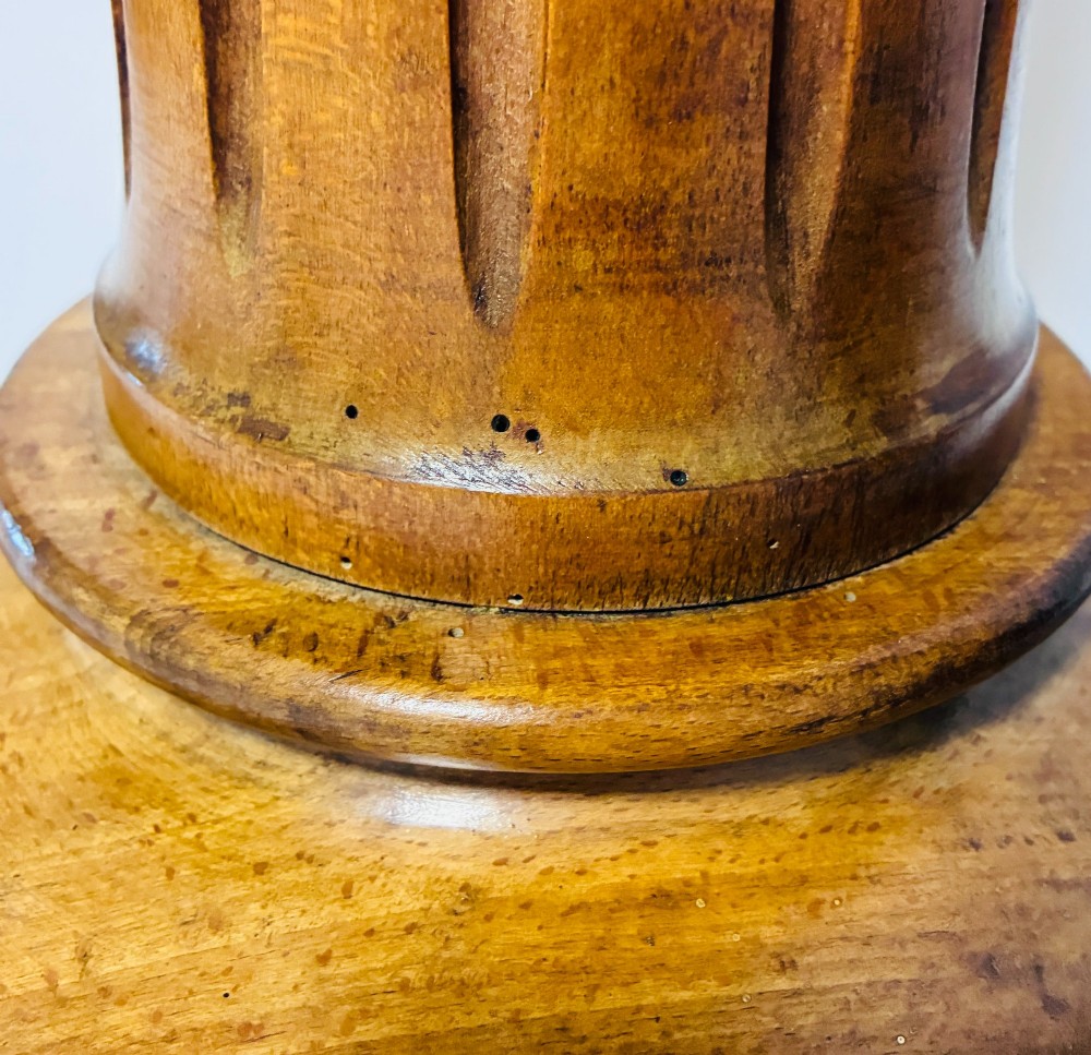 A pair of turned oak Neoclassical display pedestals featuring fluted columns and circular molded tops. View X