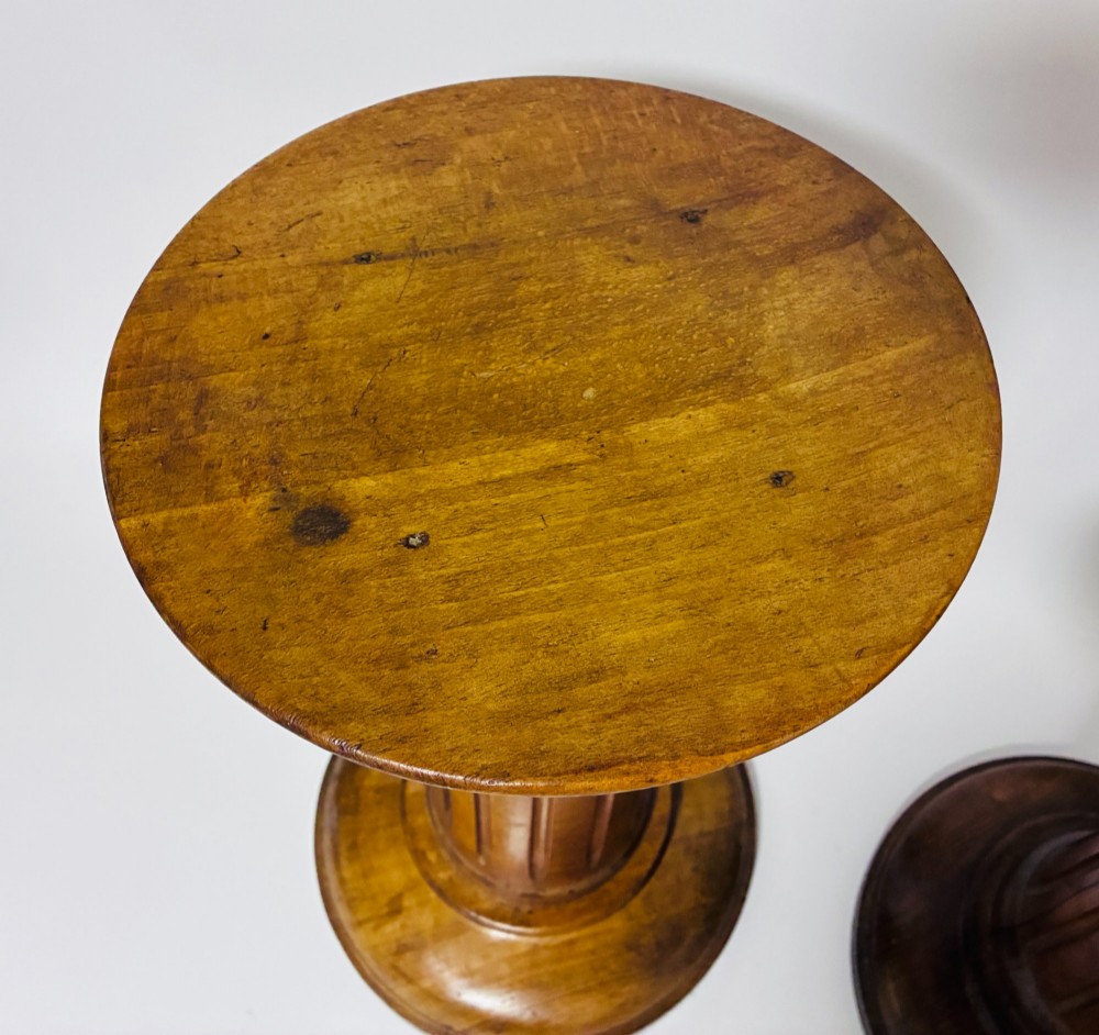 A pair of turned oak Neoclassical display pedestals featuring fluted columns and circular molded tops. View XI