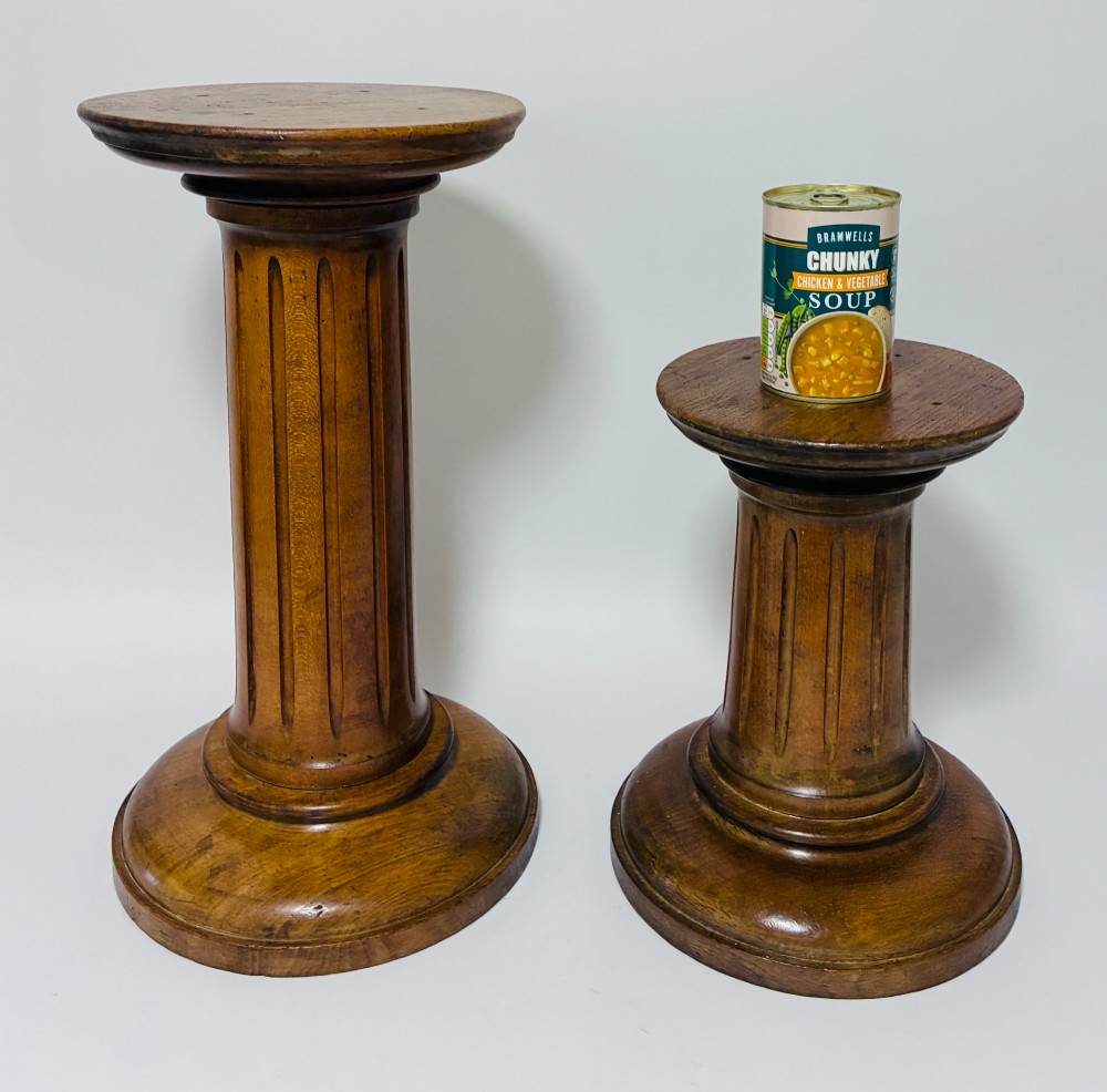 A pair of turned oak Neoclassical display pedestals featuring fluted columns and circular molded tops. View XII