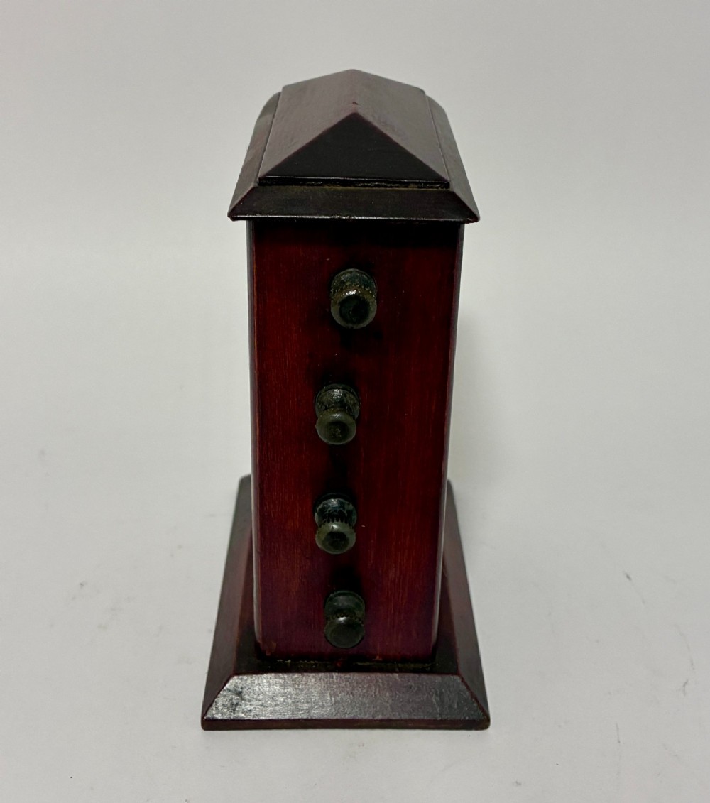 An antique wooden perpetual desk calendar featuring rotating printed scrolls for days, dates, and months displayed behind glass with turning knobs. View III