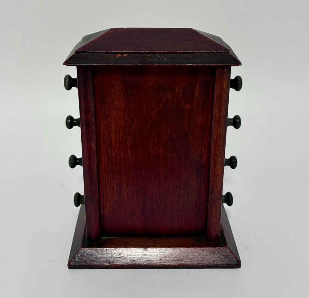 An antique wooden perpetual desk calendar featuring rotating printed scrolls for days, dates, and months displayed behind glass with turning knobs. View IV