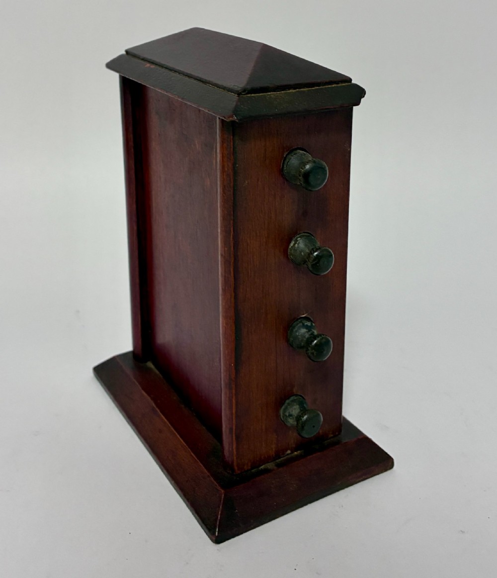 An antique wooden perpetual desk calendar featuring rotating printed scrolls for days, dates, and months displayed behind glass with turning knobs. View V
