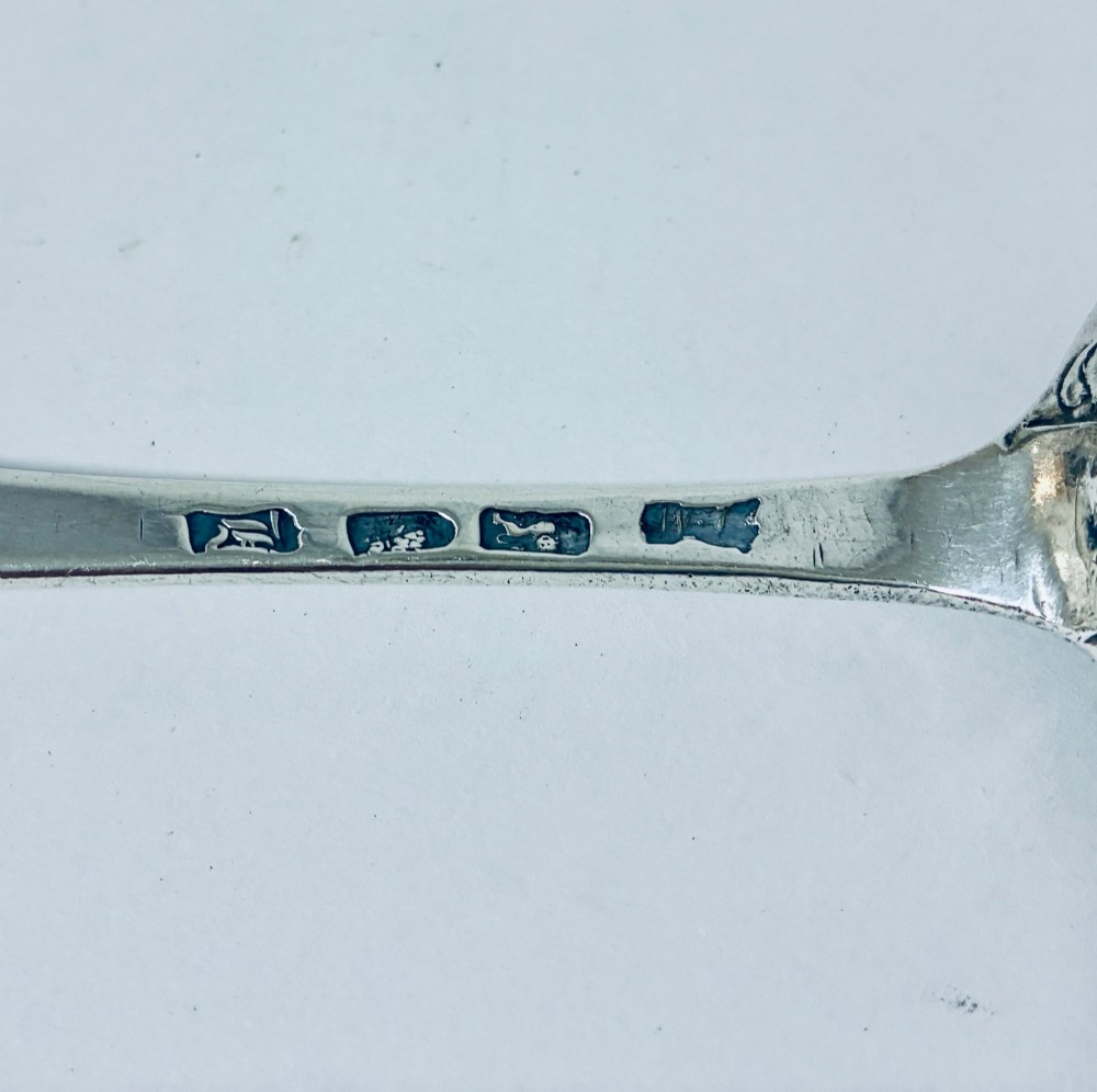 An 18th-century solid silver serving spoon featuring a plain tapered handle and an oval bowl. View VIII