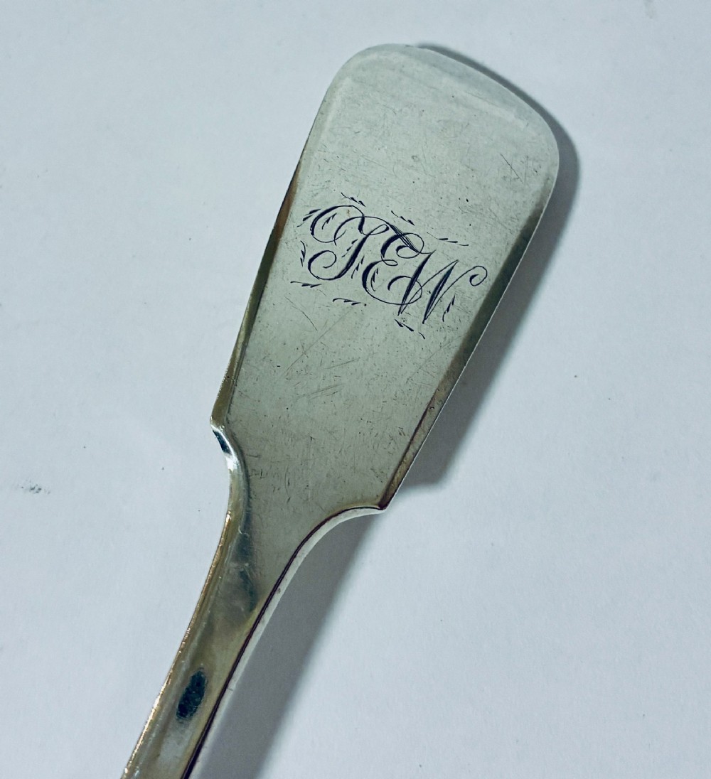 A sterling silver fiddle pattern tablespoon featuring an engraved monogram on the handle terminal and a polished oval bowl. View II