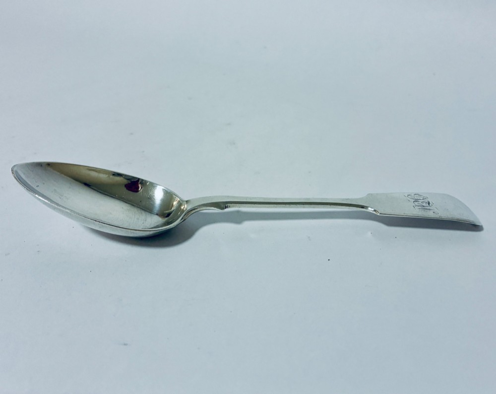 A sterling silver fiddle pattern tablespoon featuring an engraved monogram on the handle terminal and a polished oval bowl. View IV