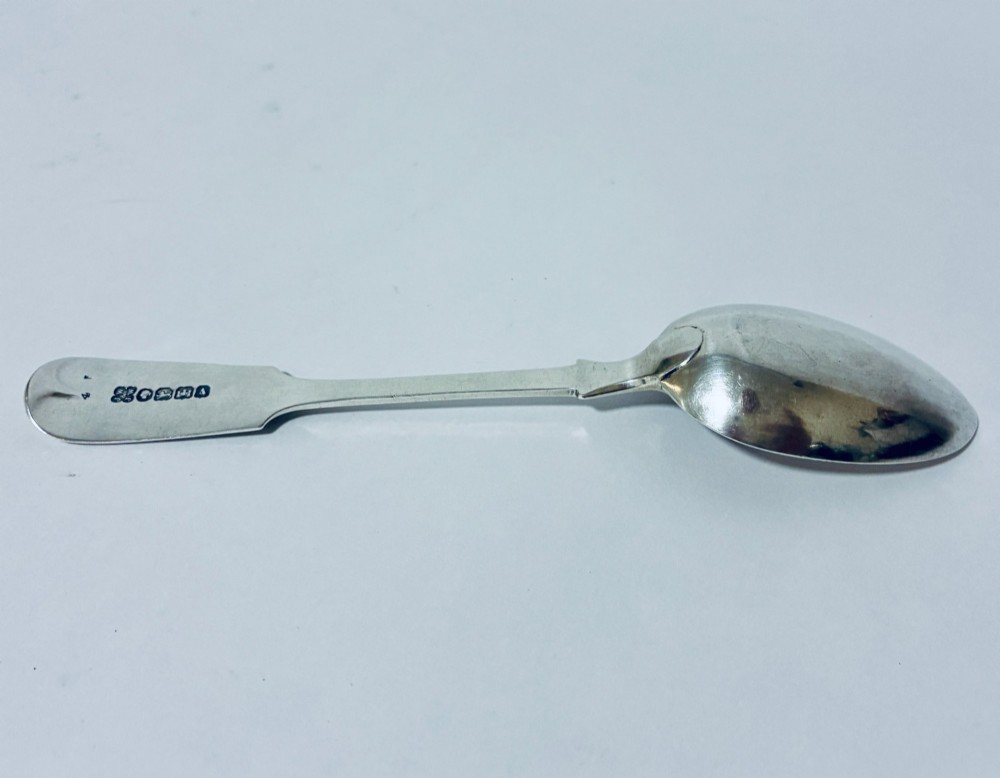A sterling silver fiddle pattern tablespoon featuring an engraved monogram on the handle terminal and a polished oval bowl. View VII