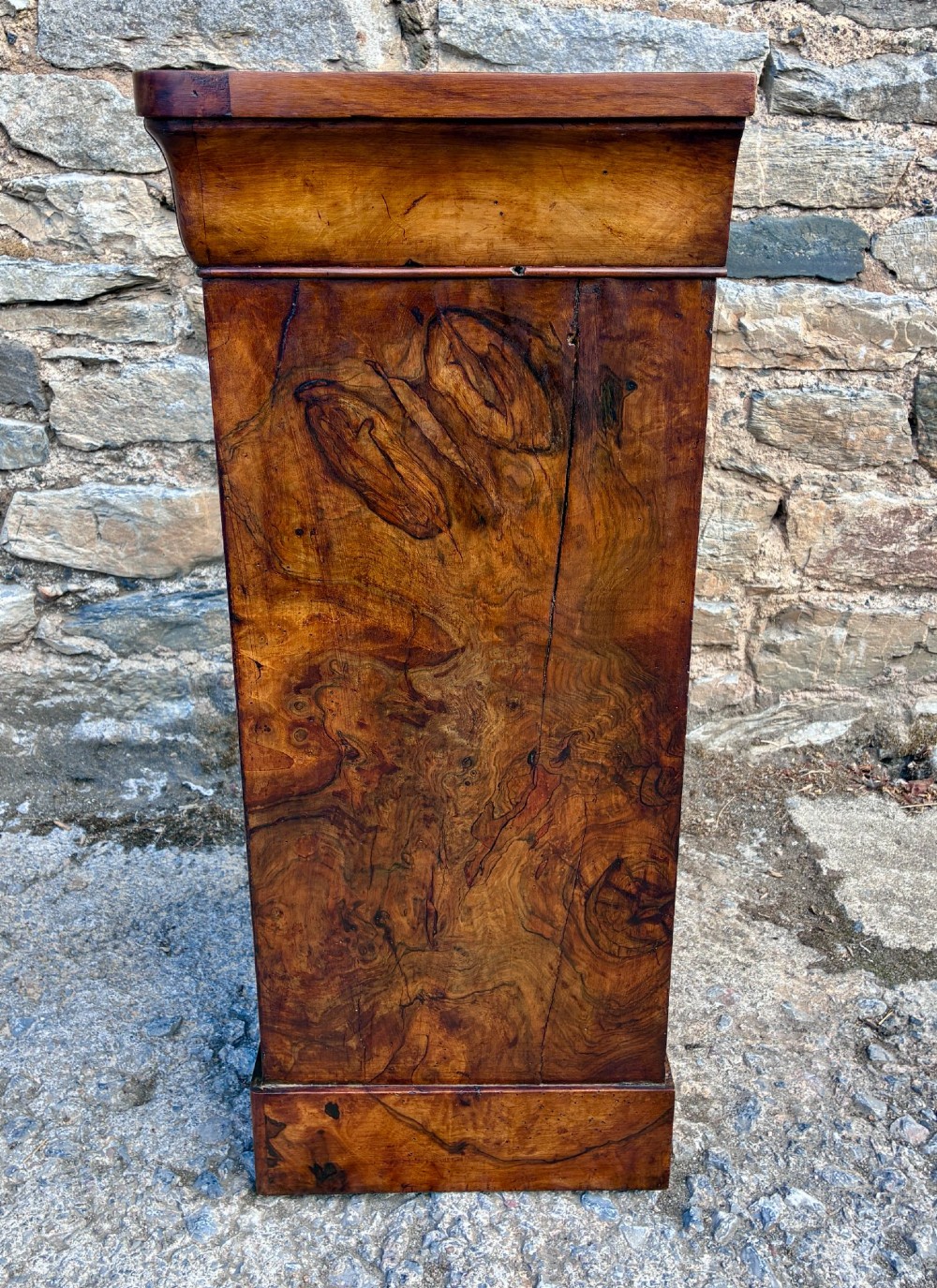 An antique French walnut pot cupboard with a figured burr walnut door panel, frieze drawer, and plinth base. View IV