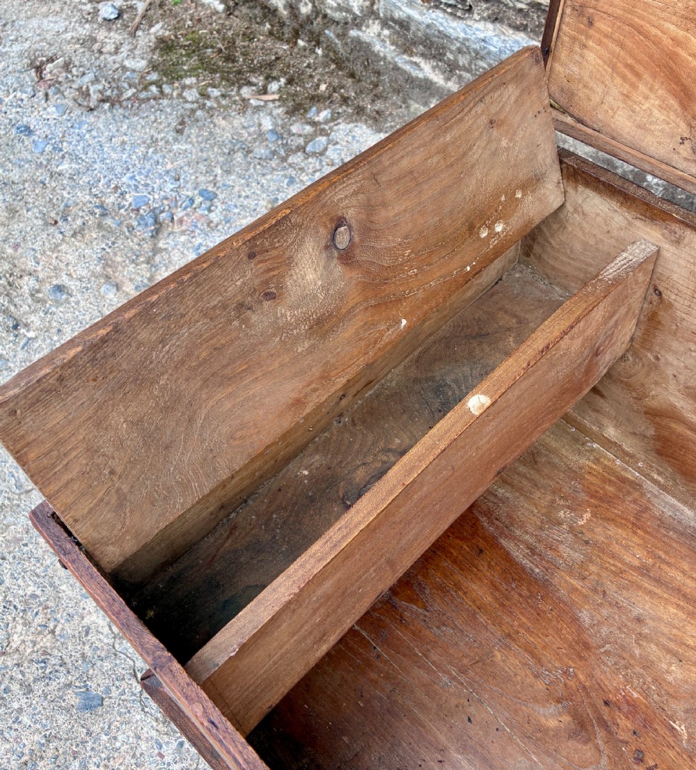 A low rectangular warm brown elm blanket box featuring a hinged top, polished finish, brass keyhole escutcheon, and bracket feet. View VI