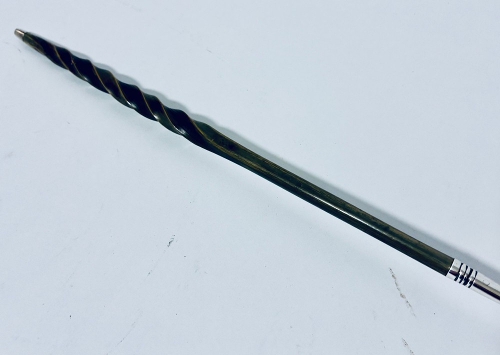 An antique Georgian silver toddy ladle featuring a deep circular silver bowl attached to a long, dark twisted handle. View X