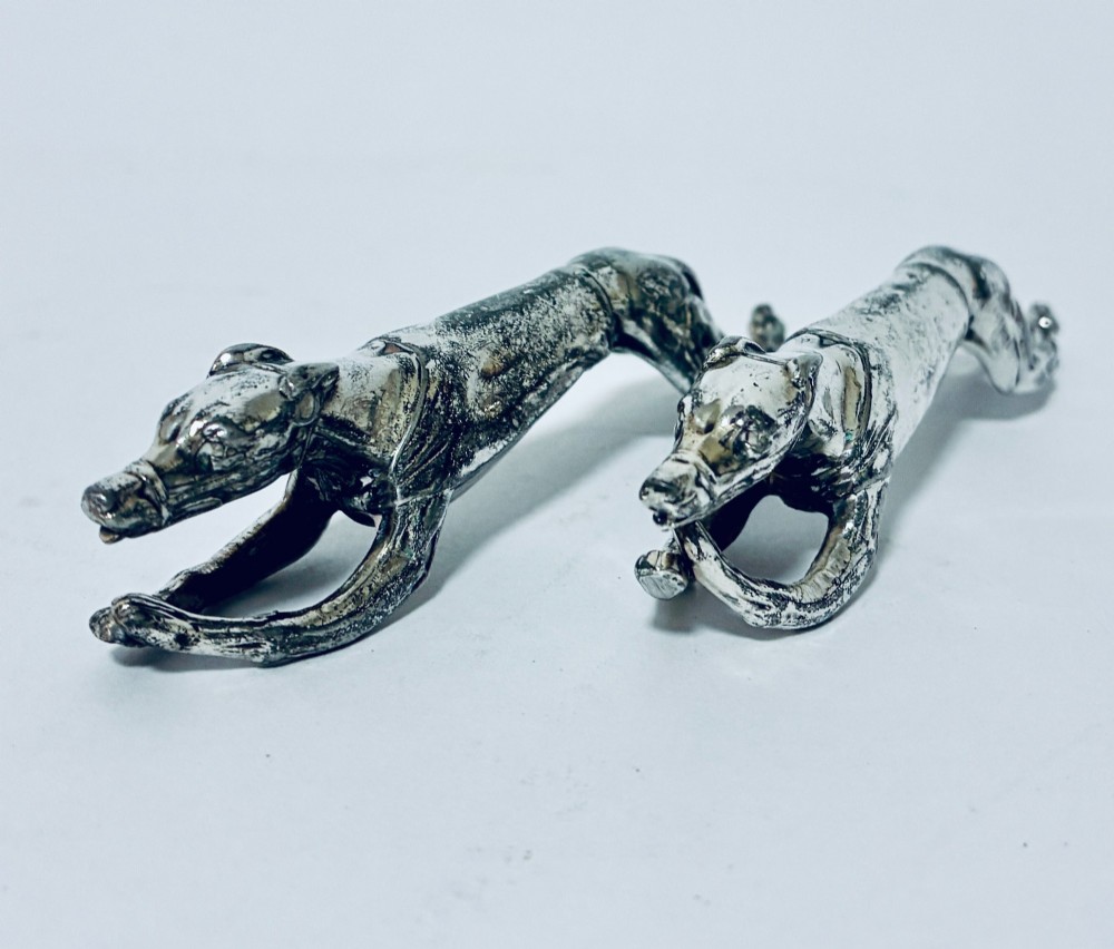A pair of silver-plated knife rests sculpted in the form of running greyhounds with outstretched legs. View III