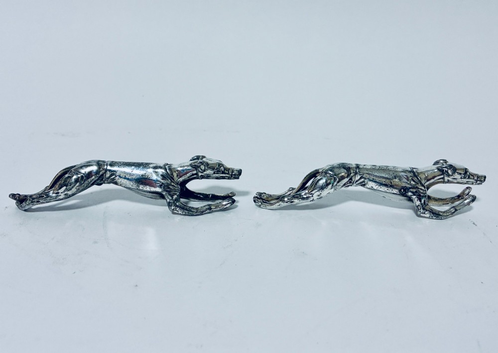 A pair of silver-plated knife rests sculpted in the form of running greyhounds with outstretched legs. View V