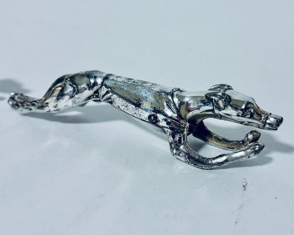 A pair of silver-plated knife rests sculpted in the form of running greyhounds with outstretched legs. View VI