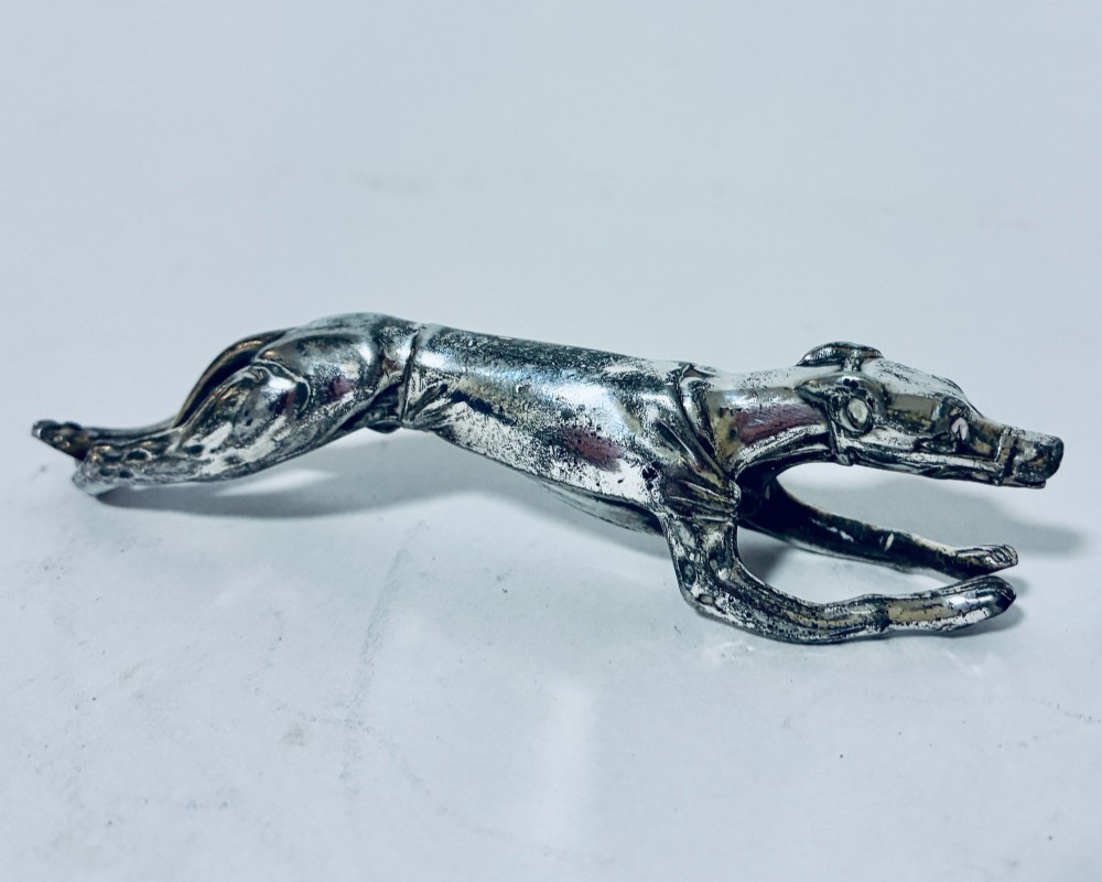 A pair of silver-plated knife rests sculpted in the form of running greyhounds with outstretched legs. View VII