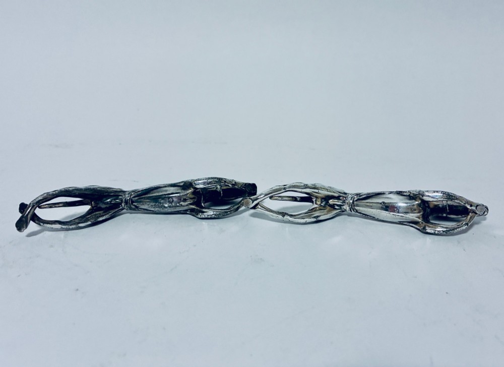 A pair of silver-plated knife rests sculpted in the form of running greyhounds with outstretched legs. View VIII