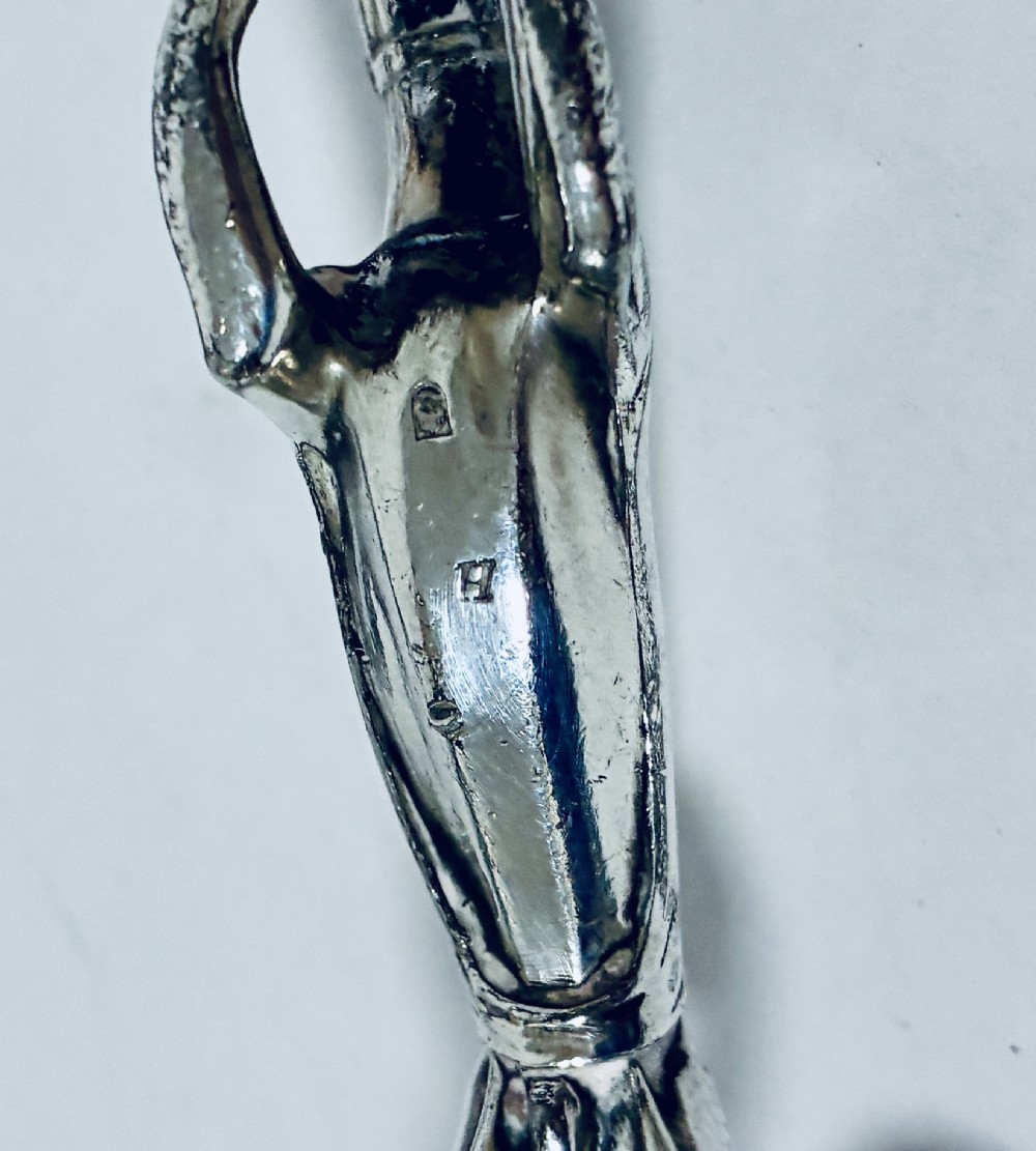A pair of silver-plated knife rests sculpted in the form of running greyhounds with outstretched legs. View IX