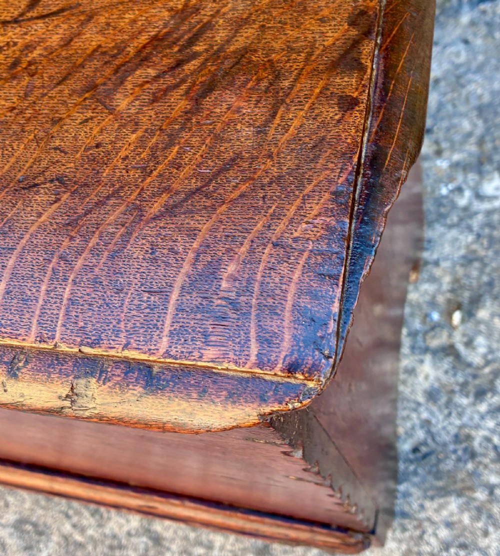 A long early 18th-century oak sword chest featuring a hinged lid, hand-carved initials H R, the date 1724 on the front panel, and a central iron escutcheon. View IX
