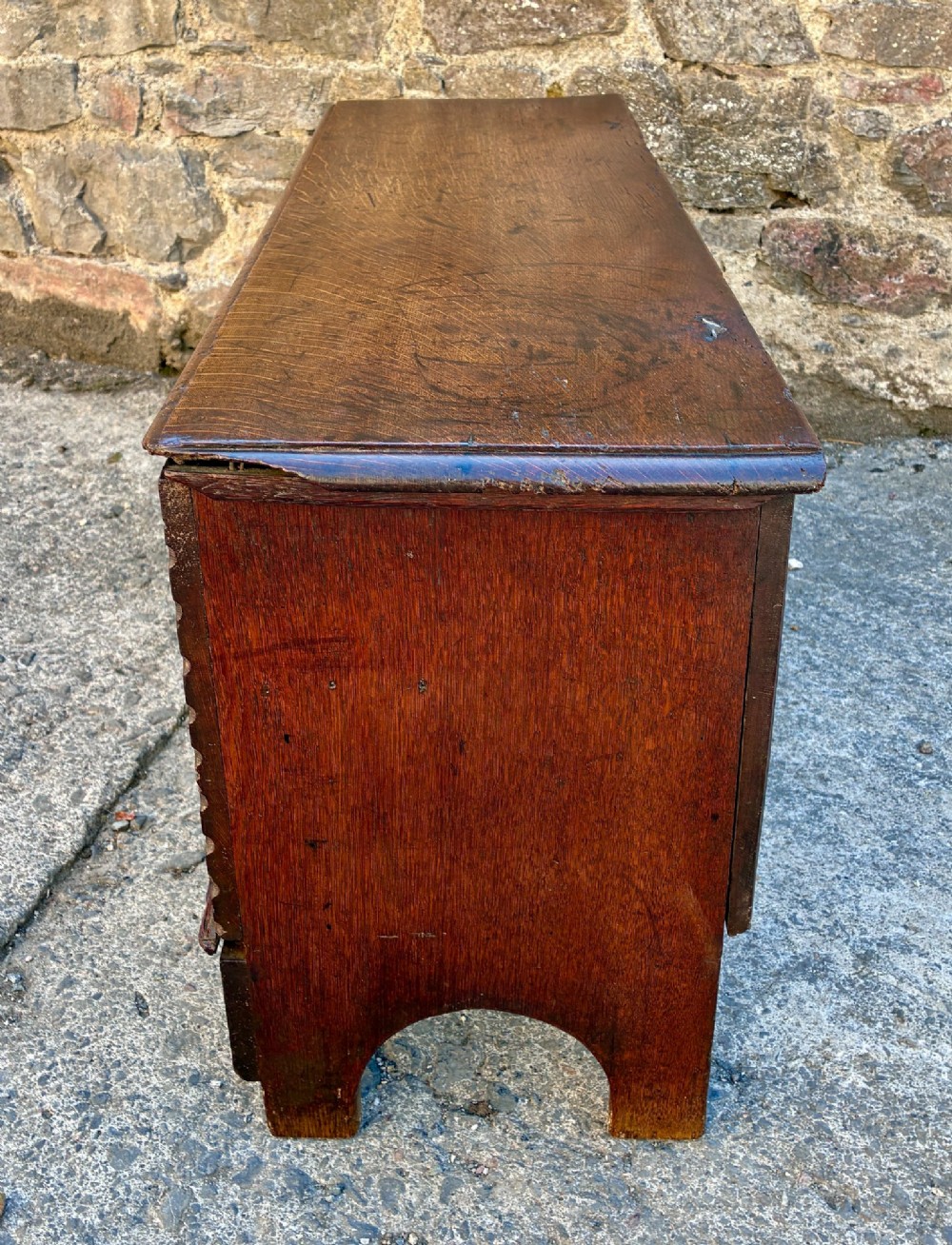 A long early 18th-century oak sword chest featuring a hinged lid, hand-carved initials H R, the date 1724 on the front panel, and a central iron escutcheon. View XI