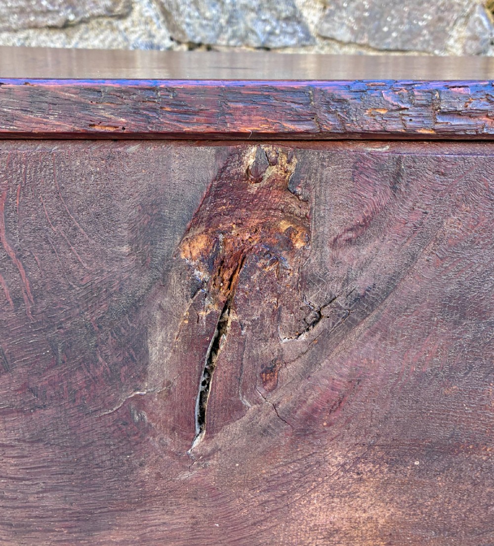 A long early 18th-century oak sword chest featuring a hinged lid, hand-carved initials H R, the date 1724 on the front panel, and a central iron escutcheon. View XIII