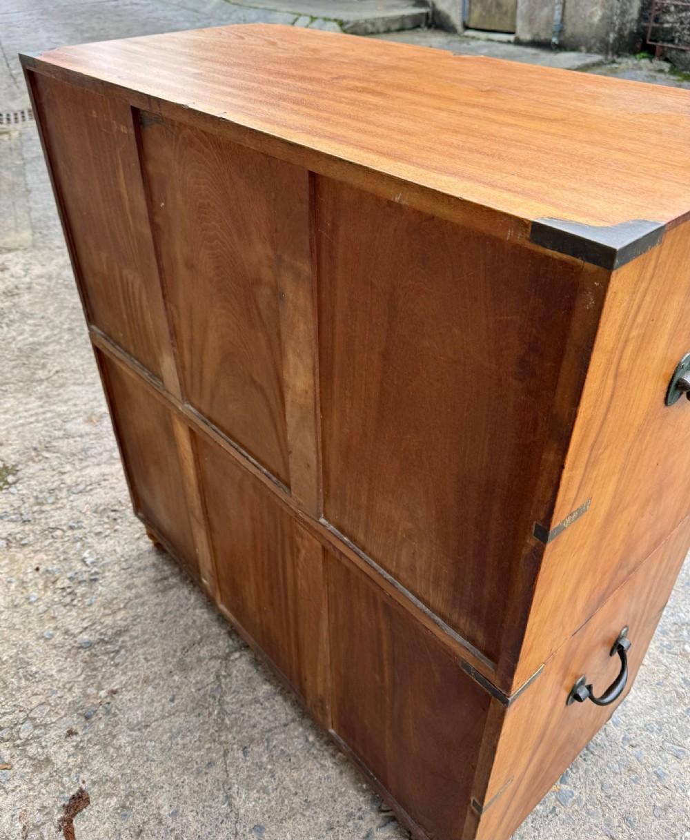 A Victorian camphor wood military campaign chest of drawers featuring two short over three long drawers with flush brass handles, corner straps, and turned feet. View XIII