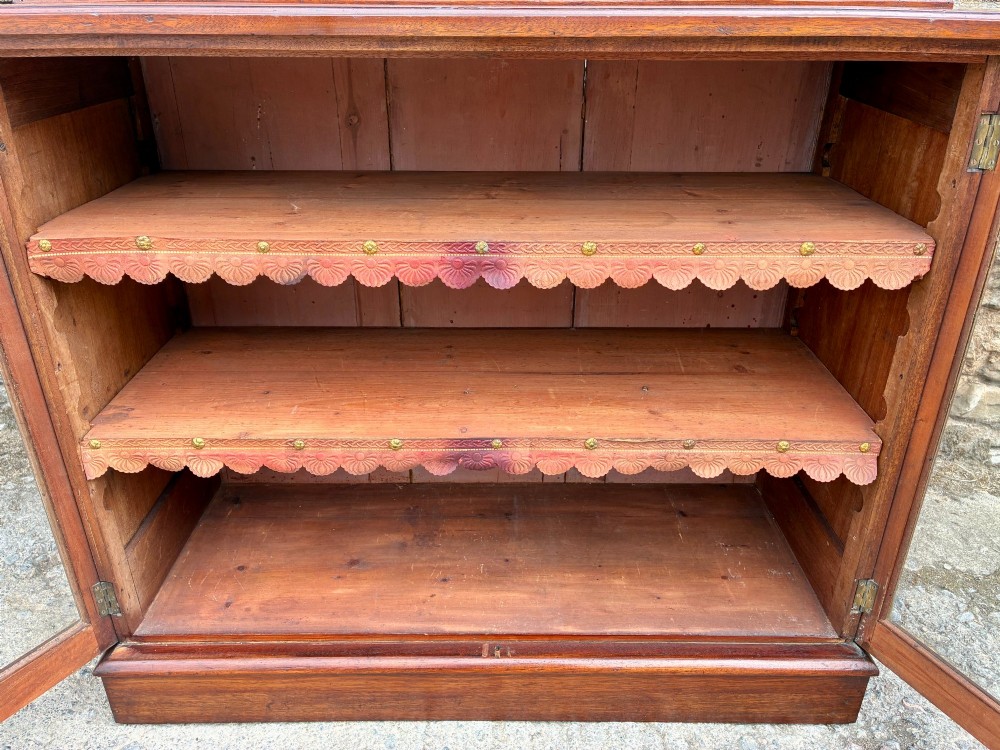 A tall Victorian mahogany cabinet featuring an upper two-door glazed section with scalloped shelf edging set above a lower matching glazed cupboard. View XIII