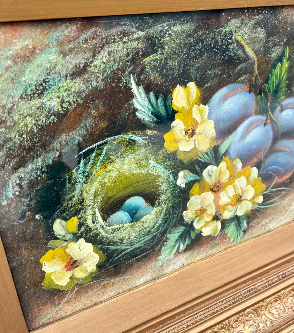 A matching pair of Victorian still life oil paintings depicting plums, primroses, and a bird nest in ornate gold gilded frames. View VI