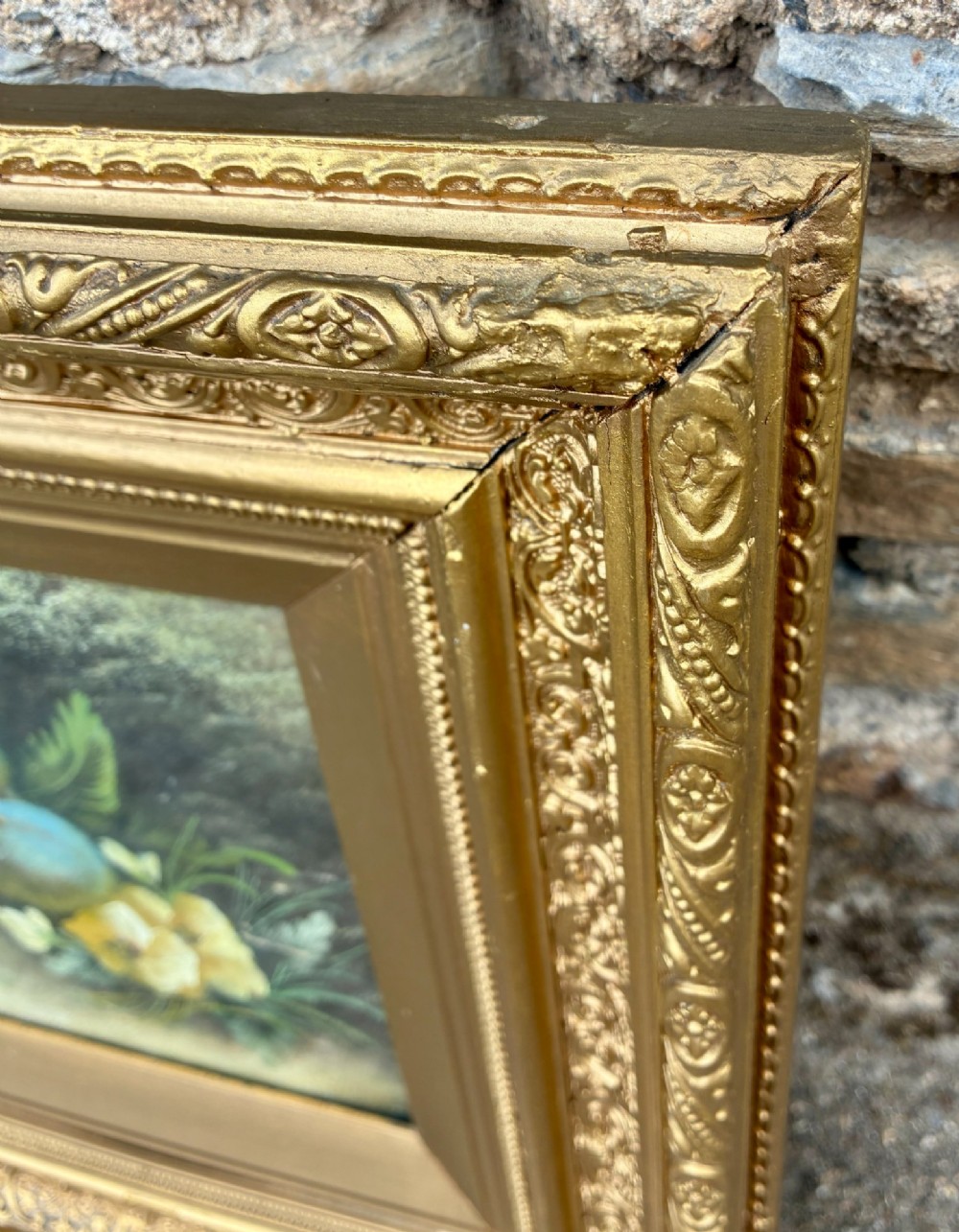 A matching pair of Victorian still life oil paintings depicting plums, primroses, and a bird nest in ornate gold gilded frames. View XI