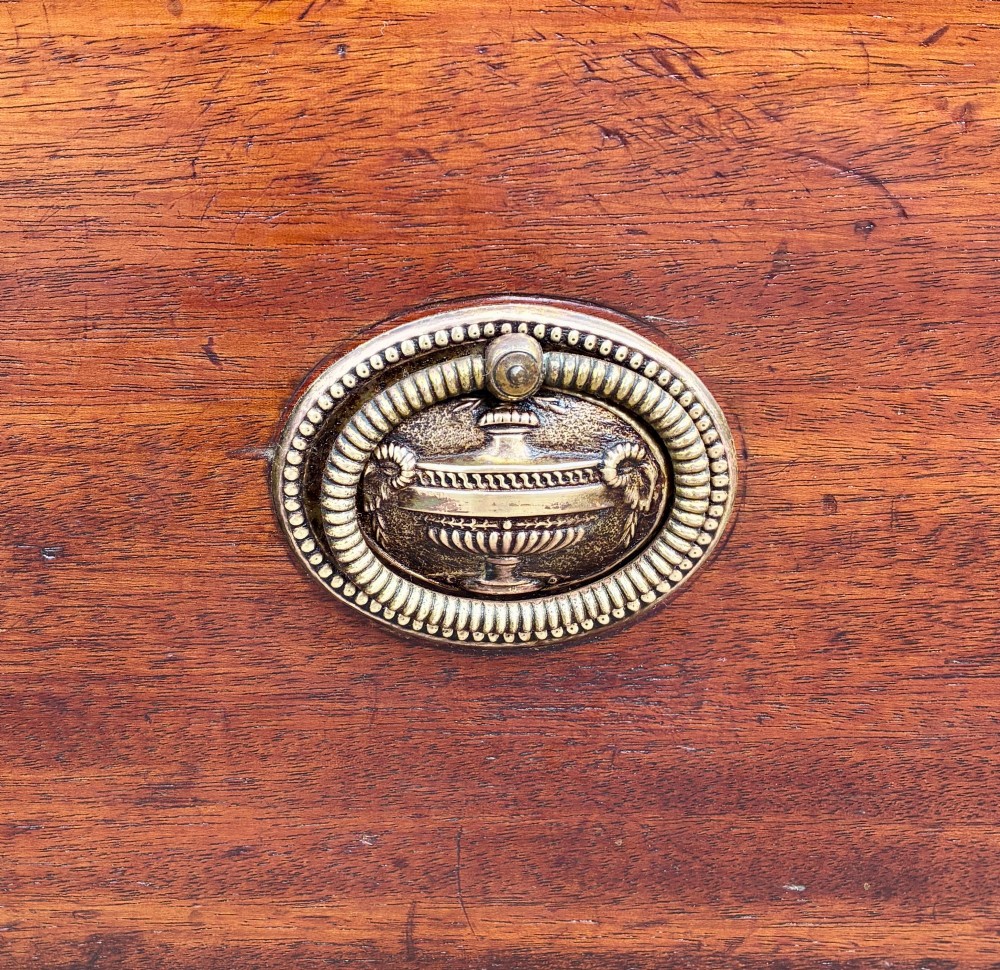 A Georgian mahogany chest of drawers featuring four graduated drawers with circular brass ring pull handles and bracket feet. View VIII
