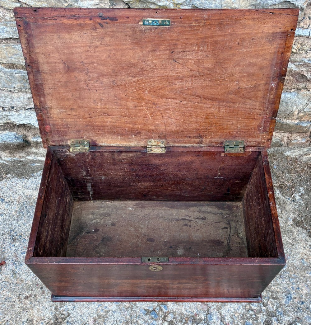 A rectangular warm brown teak storage chest featuring dovetailed corner joints and a central brass keyhole escutcheon. View III