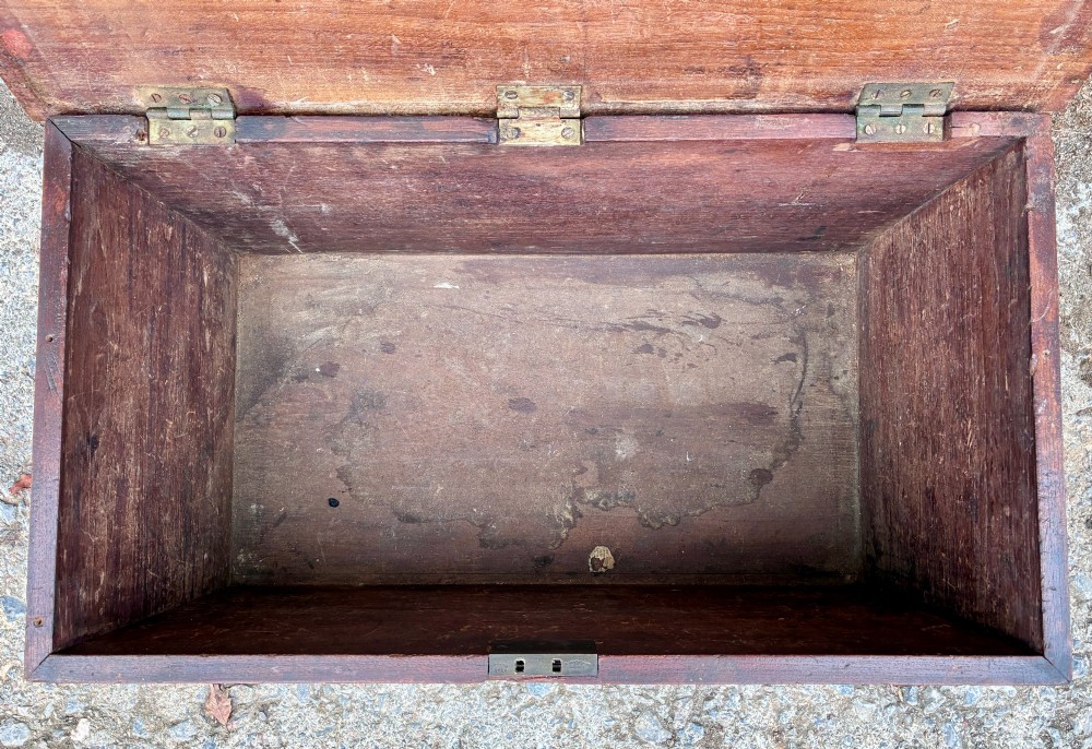 A rectangular warm brown teak storage chest featuring dovetailed corner joints and a central brass keyhole escutcheon. View IV