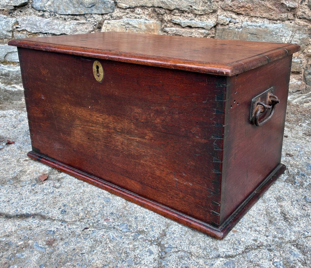 A rectangular warm brown teak storage chest featuring dovetailed corner joints and a central brass keyhole escutcheon. View VI