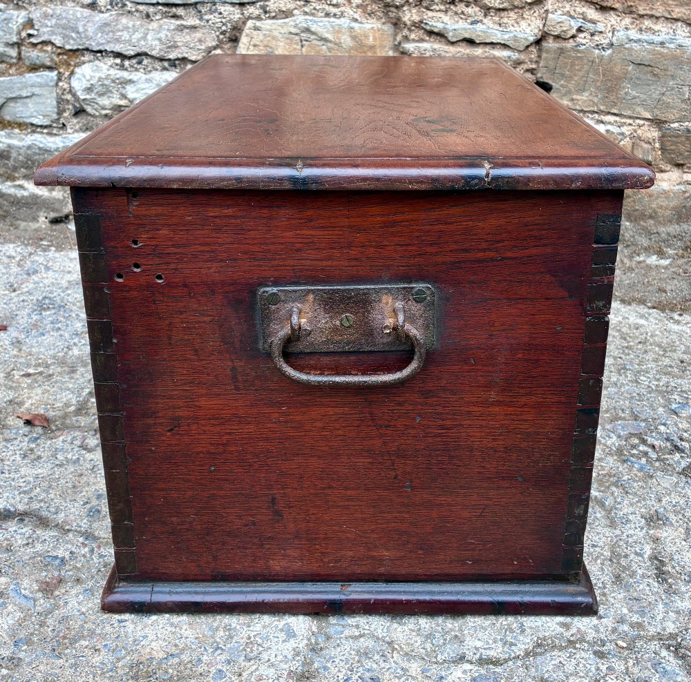 A rectangular warm brown teak storage chest featuring dovetailed corner joints and a central brass keyhole escutcheon. View VII