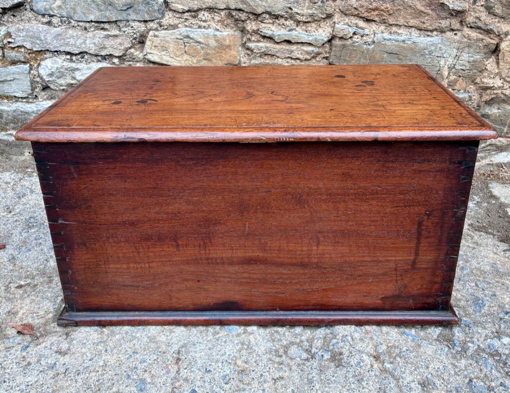 A rectangular warm brown teak storage chest featuring dovetailed corner joints and a central brass keyhole escutcheon. View VIII