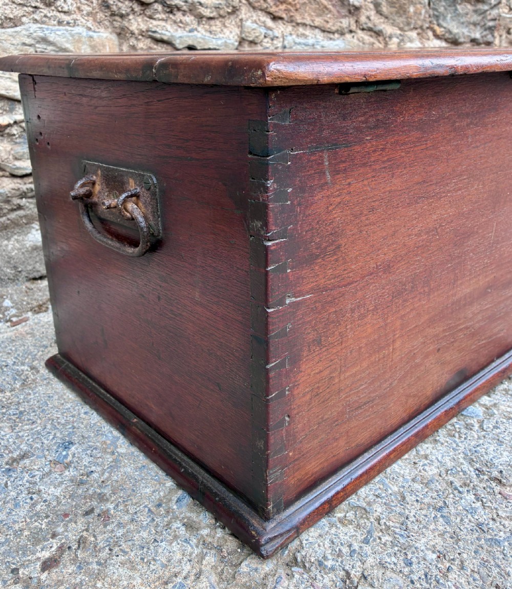 A rectangular warm brown teak storage chest featuring dovetailed corner joints and a central brass keyhole escutcheon. View IX
