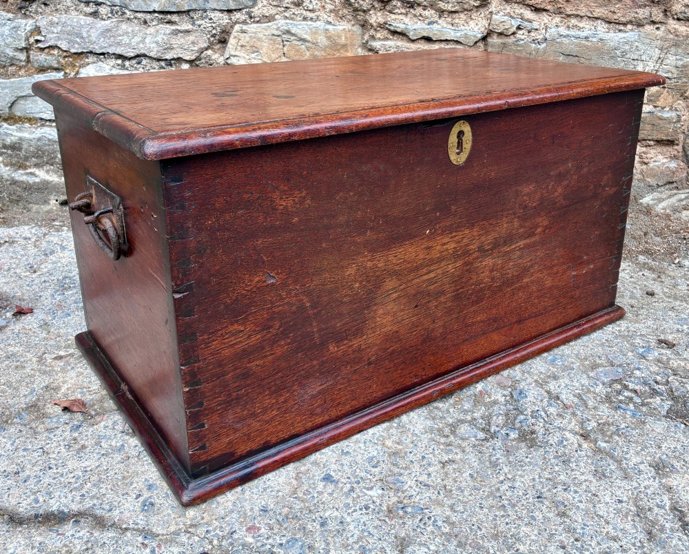 A rectangular warm brown teak storage chest featuring dovetailed corner joints and a central brass keyhole escutcheon. View XII