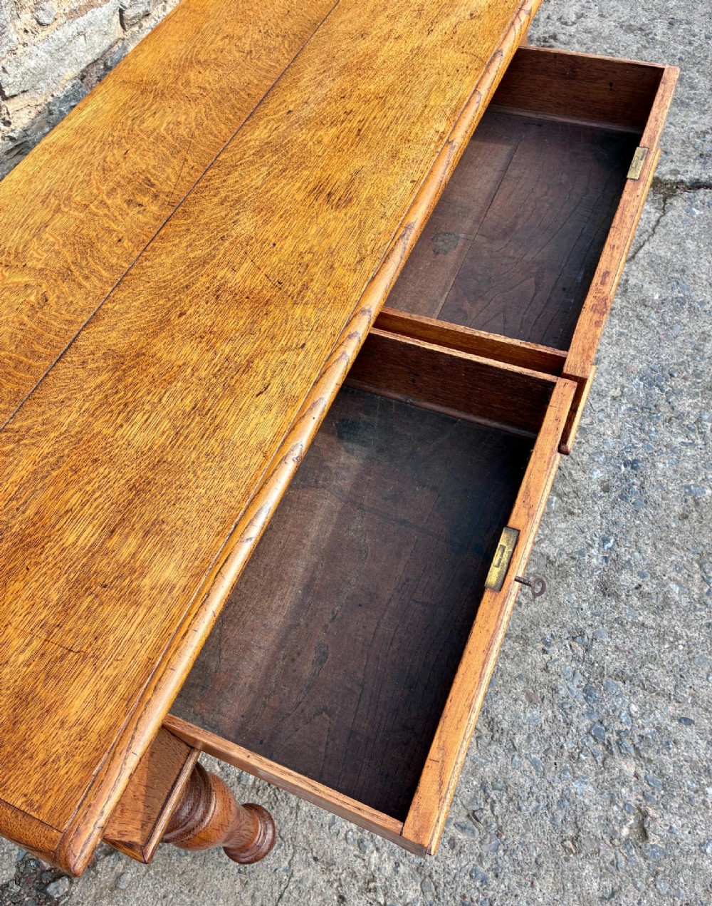 A Victorian golden oak console table featuring a rectangular top with a moulded edge, two frieze drawers, and four turned legs. View VIII