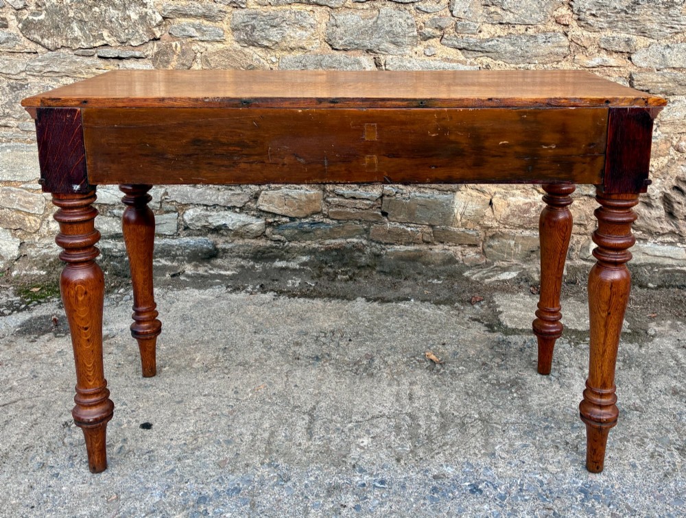 A Victorian golden oak console table featuring a rectangular top with a moulded edge, two frieze drawers, and four turned legs. View XII