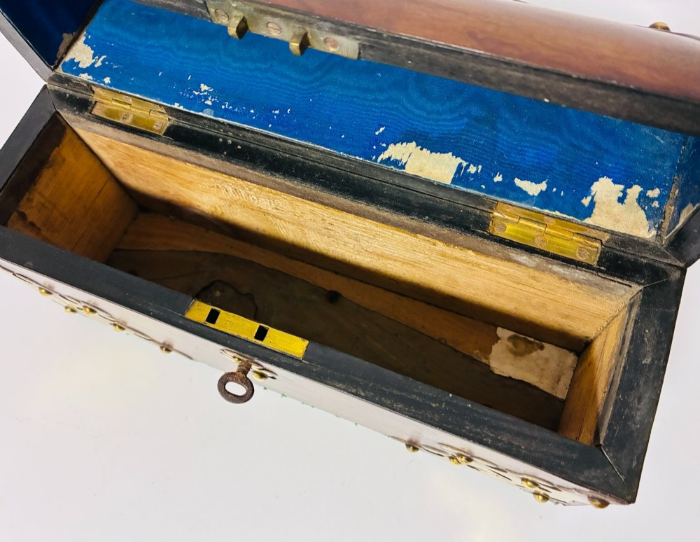 A domed Victorian walnut box featuring decorative pierced brass corner mounts and a central brass keyhole. View III