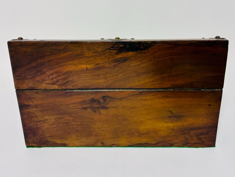 A domed Victorian walnut box featuring decorative pierced brass corner mounts and a central brass keyhole. View VII