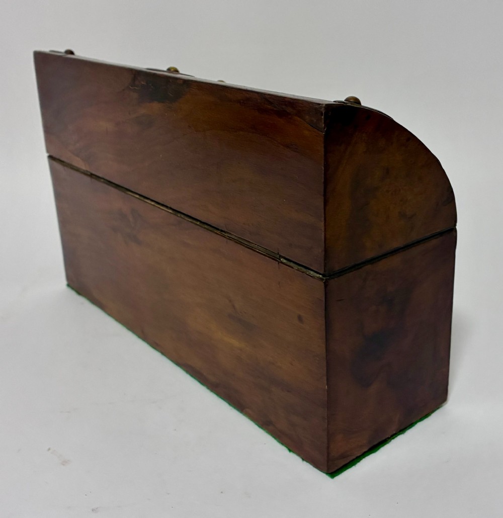 A domed Victorian walnut box featuring decorative pierced brass corner mounts and a central brass keyhole. View VIII