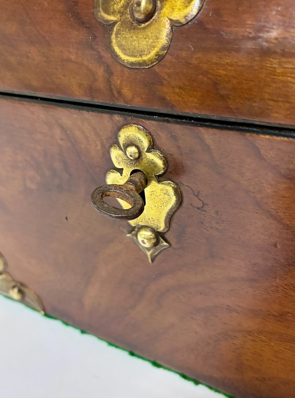 A domed Victorian walnut box featuring decorative pierced brass corner mounts and a central brass keyhole. View XI