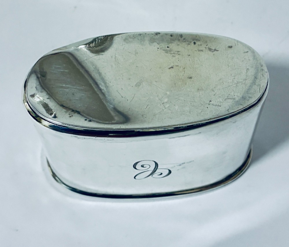 An antique cut-glass hip flask featuring a hallmarked sterling silver collar, chased cap, and a removable silver base cup engraved with the letter C. View XIV